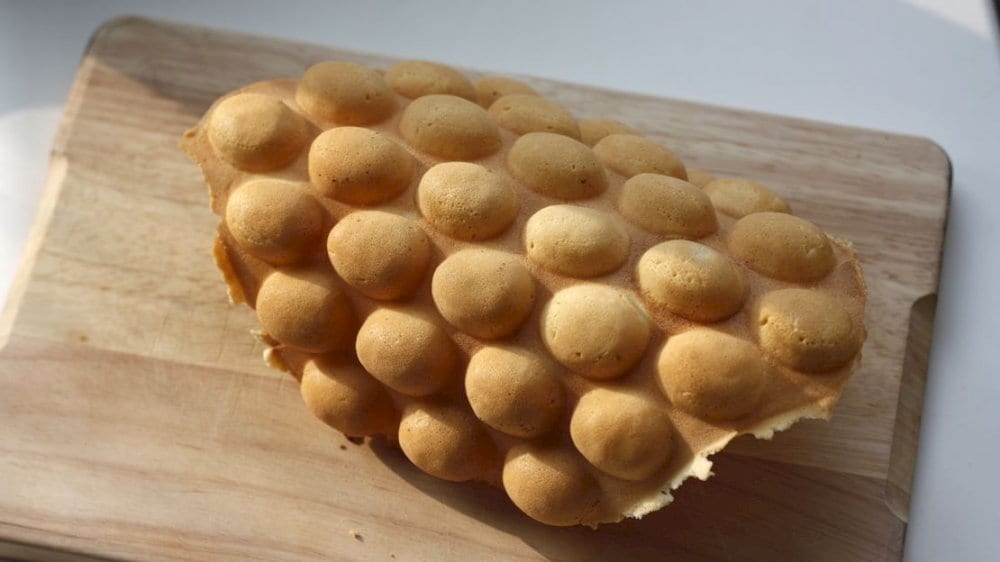 It’s made from a unique batter cooked in a special waffle iron, giving it a distinctive bubble-like shape